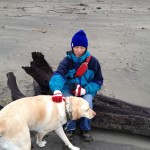 Theo and Zoie sitting on the beach at Pacific City